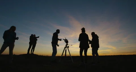 Friends stargazing together using a professional telescope Stock Footage 97239447