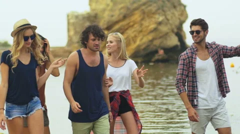 Friends staying on the beach Stock Footage 68798753