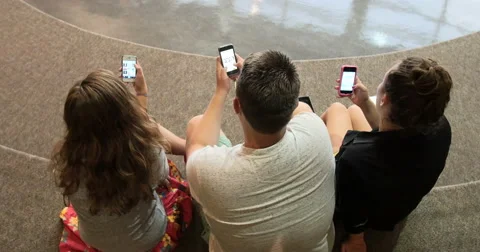 Friends (students) using their smart cell phones in school. Ultra HD 4K Stock-Footage 45575452