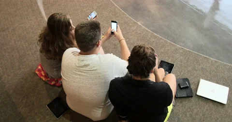Friends (students) using their smart cell phones in school. Ultra HD 4K Stock Footage 45621331