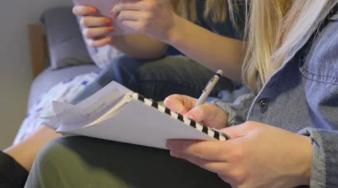Friends Study Together, One Takes Notes, The Other Checks Her Tablet Stock-Footage 62679416