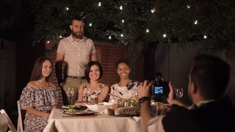 Friends taking photo while dining Stock Footage