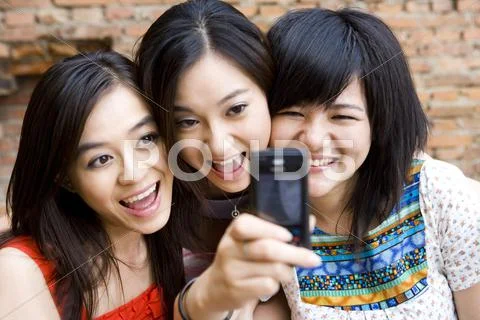 Friends taking photos with mobile phone Stock Photos