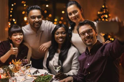Friends taking selfie on christmas dinner at home Stock Photos