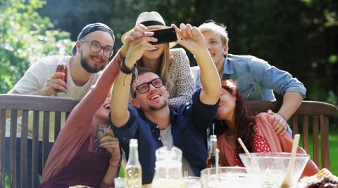 Friends taking selfie at party in summer garden Stock Footage