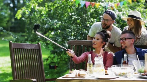 Friends taking selfie at party in summer garden Stock Footage