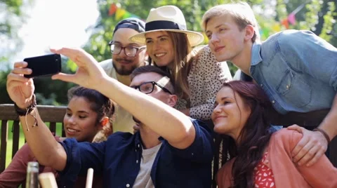 Friends taking selfie at party in summer garden Stock Footage