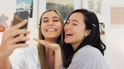 Friends taking selfie with a phone on the wedding morning preparing for the day Stock Photos