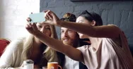 Friends Taking Selfie Photograph Self Portrait In Cafe Stock Footage