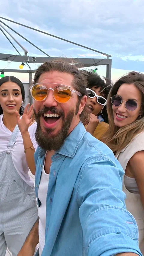 Friends taking a selfie at rooftop party Stock Footage 311801086