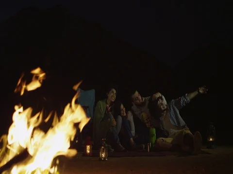 Friends taking selfie using mobile camera around campfire. Stock Footage 69473601