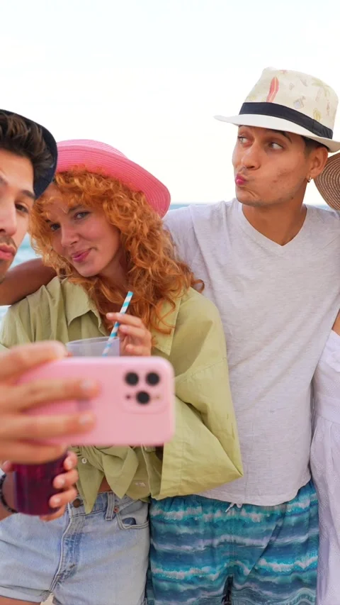 Friends taking selfies on the beach, enjoying summer cocktails Stock Footage 310185572