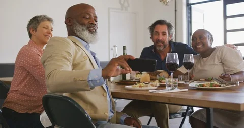 Friends taking selfies while eating Видео 124704209