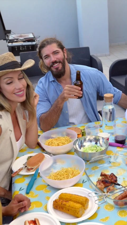 Friends taking selfies while enjoying rooftop barbecue Stock Footage 311801041