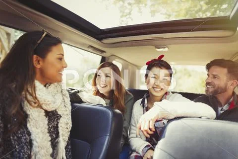 Friends talking and riding in car Stock Photos