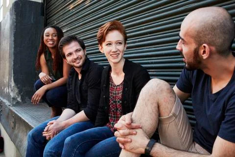 Friends talking on loading dock Stock Photos