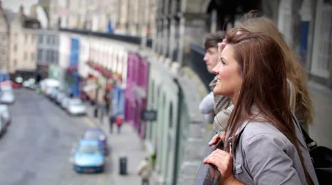 Friends talking out and about in the city. Teenagers in Edinburgh City Scotland. 動画素材 32936731