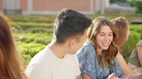 Friends talking while sitting in the street Stock Footage 207454840