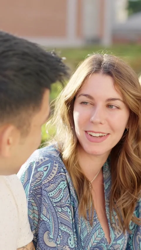 Friends talking while sitting in the street Stock Footage 239908843