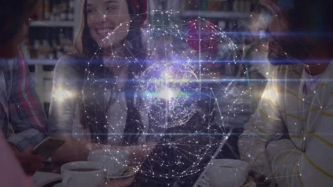 Friends tapping smartphone causing tech hologram globe hovering above cafe table Stock Footage 311585796