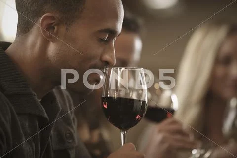 Friends tasting wine together Stock Photos