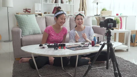 Friends testing foundation while recording video Stock Footage 133470749