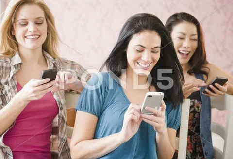 Friends Text Messaging On Cell Phones Together