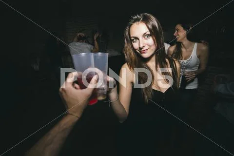 Friends toasting and drinking in nightclub Stock Photos