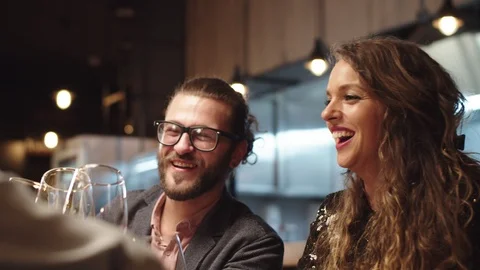 Friends toasting with wine while sitting in restaurant. Stock Footage 125081861