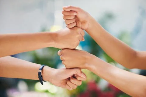 Friends uplift one another. two colleagues working in a nursery with their fists Stock Photos