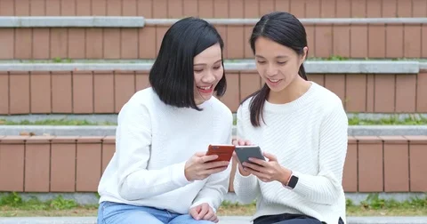 Friends using cellphone together Stock Footage 84278903