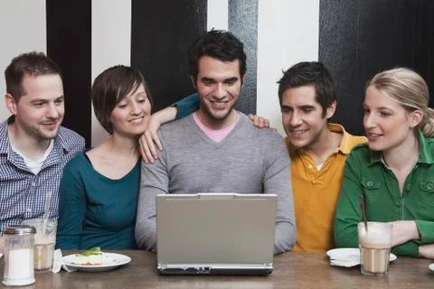 Friends using laptop. Stock Photos