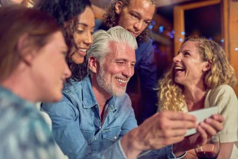 Friends using smart phone Stock Photos