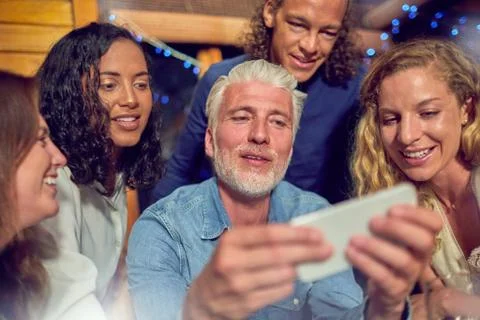 Friends using smart phone Stock Photos