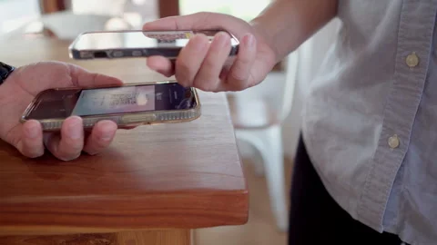 Friends using smartphone for payment at cafe restaurant for split payment Stock Footage 259643773