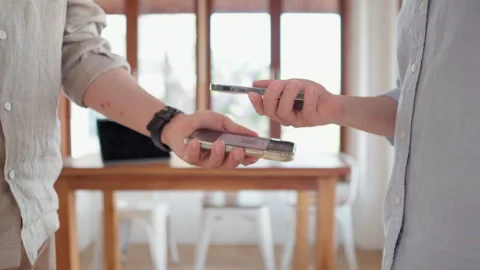 Friends using smartphone for payment at cafe restaurant for split payment Stock Footage 259643892