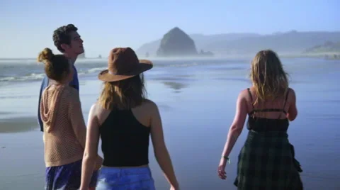 Friends walk down beach together Stock Footage 52603432