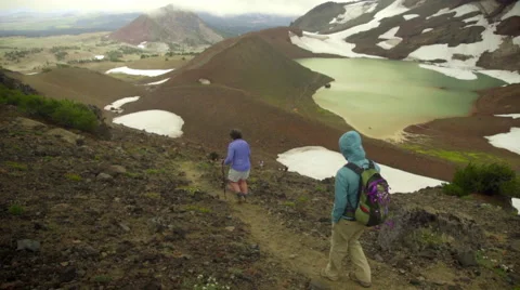 Friends walk down mountain trail Stock Footage 59516926