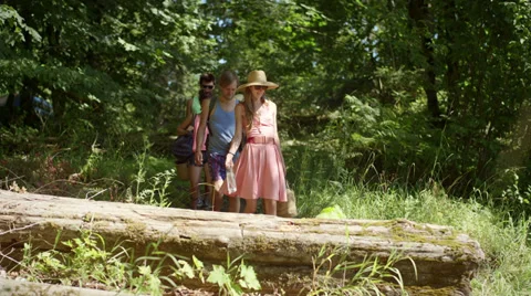 Friends walk through a forest path to get to the beach Stock Footage 34022941