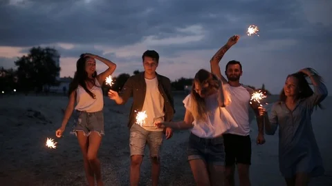 Friends walking, dancing and having fun during night party at the seaside with Stock Footage 92666819
