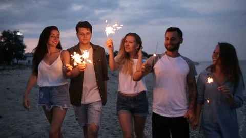 Friends walking, dancing and having fun during night party at the seaside with Stock Footage 92742271