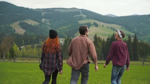 Friends walking in mountains valley Stock Footage 76245938