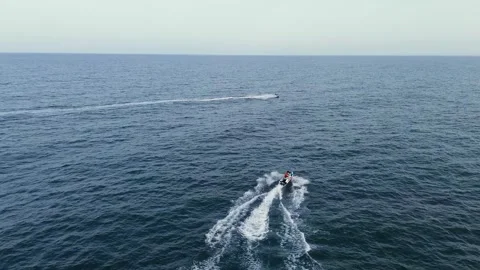 Friends water skiing over inflatable donut pulled by boat Stock Footage 246791802