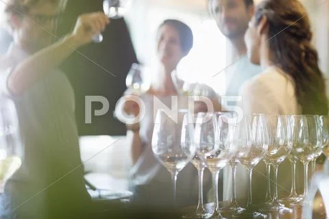 Friends wine tasting in winery tasting room Stock Photos