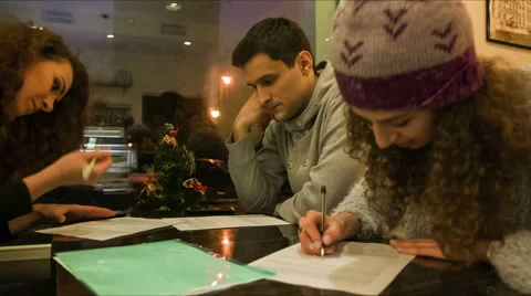 Friends write on paper Stock Footage 60444794