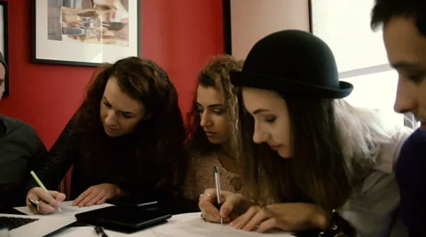Friends write on paper Stock Footage 60585328