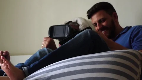 Friends/Father and Son Lying Down and Having Fun with VR Googles and Tablet Stock Footage 82907824
