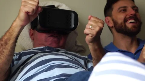Friends/Father and Son Lying Down and Having Fun with VR Googles and Tablet Stock Footage 82907977