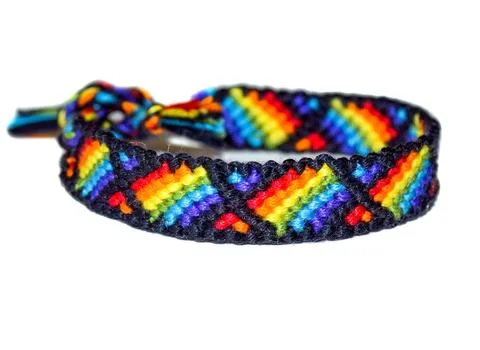 Friendship bracelet, woven of thread, with pattern of the rainbow flag,  kn.. Foto stock