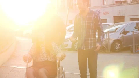 Friendship, fun -friends quickly push a woman's wheelchair Stock Footage 166174584